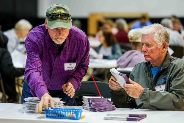 Daniel Simms, left, Steve Keller and other stipend workers open mail-in ballots as part of the extraction process before sending them to the tabulation room at the Contra Costa County Registrar of Voters in Martinez, Calif., Friday, May 29, 2026. (Ray Chavez/Bay Area News Group)