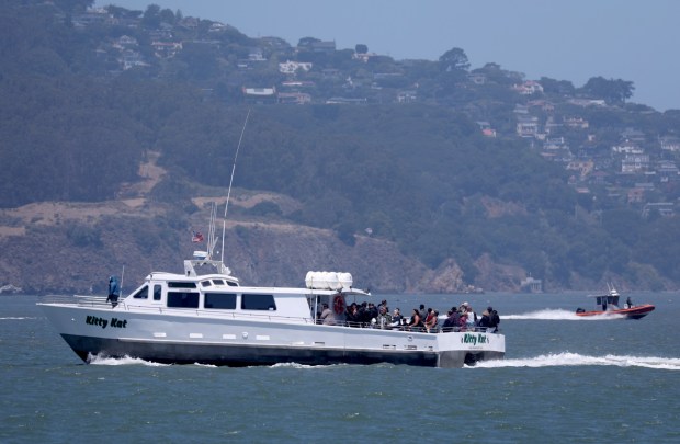 A Coast Guard rigid-hull inflatable boat, right, passes a whale-watching boat heading out to sea in San Francisco, Calif., on Wednesday, July 15, 2026. One person died and three are missing after a boat capsized near Alcatraz Island yesterday while on the water for a memorial service. (Jane Tyska/Bay Area News Group)