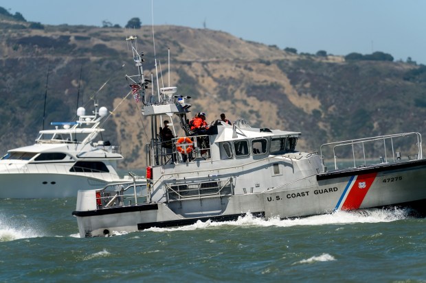 A US Coast Guard vessel navigates the San Francisco Bay while assisting a boat that got stuck on Alcatraz Island's underwater rocks on Wednesday, July 15, 2026, in San Francisco. (AP Photo/Noah Berger)