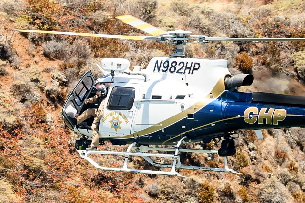 A California Highway Patrol helicopter flies along the Sausalito, Calif. shoreline as search and rescue operations continue for victims of a Tuesday boat sinking on Wednesday, July 15, 2026. (AP Photo/Noah Berger)