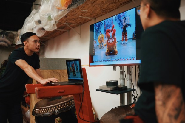Sun Hing team leader Kevin Nguyen, left, goes over video of practice with team member Jefferson Dzoan, right, Wednesday, April 1, 2026, in San Jose, Calif. (Yu Wang)
