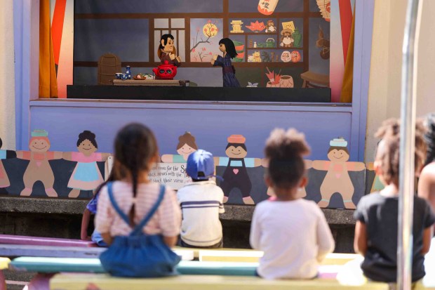 Visitors watch a puppet show by Children's Fairyland puppet theater director Randal Metz in Oakland, Calif., Thursday, June 27, 2026. Metz, who said he started at age 10, has been a puppeteer for 57 years. (Ray Chavez/Bay Area News Group)