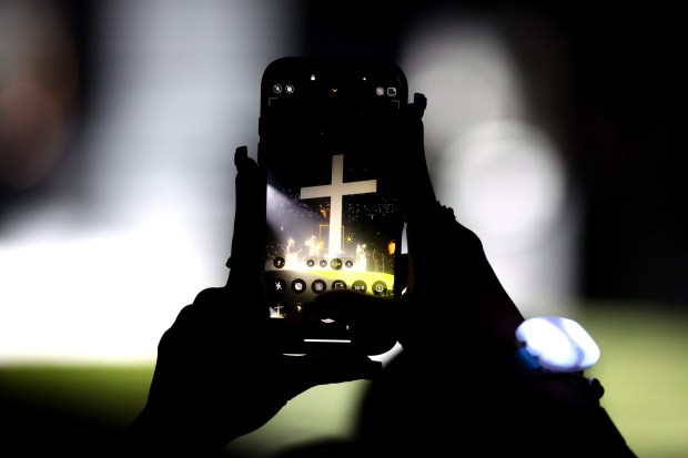 A fan takes photos with her cellphone of Forrest Frank performing during a Christian music concert at Oakland Arena in Oakland, Calif., on Tuesday, July 14, 2026. (Ray Chavez/Bay Area News Group)