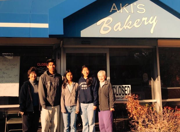 Darryl Tom and his siblings stand between his mother Penny Tom and grandmother Suyeko "Sue" Toyoshima outside Aki's Bakery on Meridian Avenue before it closed in 2007. (Photo courtesy of Darryl Tom)
