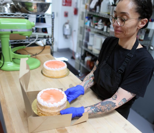 Tamara Esparza boxes a guava cake in the kitchen of Honey and Pearl on Sunday, June 28, 2026, in Emeryville. (Aric Crabb/Bay Area News Group)