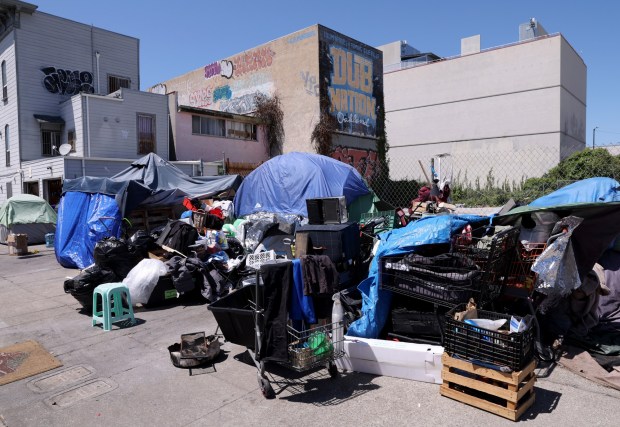 A Golden State Warriors mural overlooks a homeless encampment along 6th Street near Webster Street in downtown Oakland, Calif., on Monday, June 1, 2026. (Jane Tyska/Bay Area News Group)