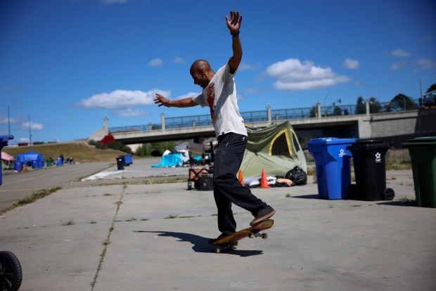 Jameel Smith skateboards at a homeless encampment near Washington Boulevard and Osgood Road in Fremont, Calif., on Thursday, April 2, 2026. (Nhat V. Meyer/Bay Area News Group)