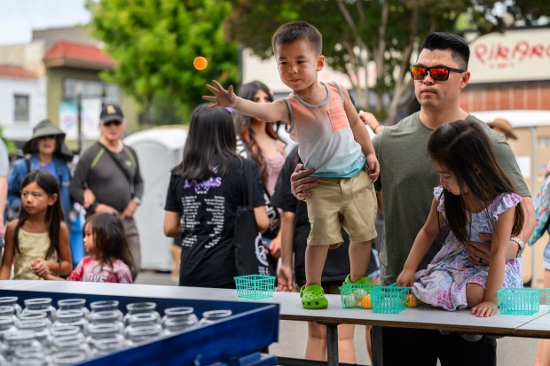 Dylan Lew, 3, of San Ramon, tosses an orange ping-pong ball while playing games at the San Jose Obon Festival in San Jose, Calif., on Saturday, July 11, 2026. (Jose Carlos Fajardo/Bay Area News Group)