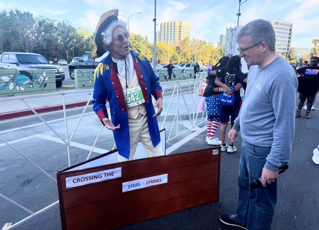 Valley Health Foundation CEO Michael Elliott, right, talks to Wayne Mancari, who dressed as George Washington crossing the Delaware to win the Independence Day category of the Stars and Strides Run in downtown San Jose on Saturday, July 11, 2026. (Sal Pizarro/Bay Area News Group)