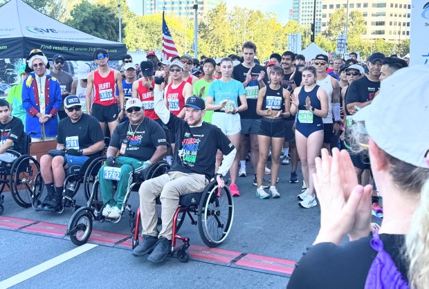 Jeff Garmany raises his hand to acknowledge the cheers from the crowd as he prepares to start the wheelchair division of the Stars and Strides Run in downtown San Jose on Saturday, July 11, 2026. (Sal Pizarro/Bay Area News Group)