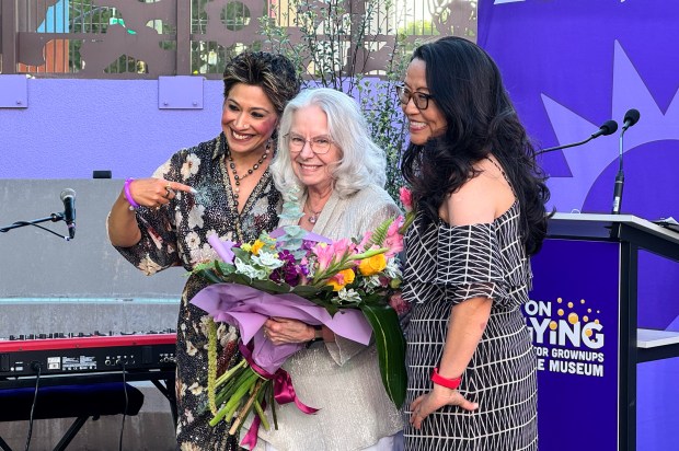 Debbie McKenzie, associate director of development for the Children's Discovery Museum, receives a bouquet from board chair Monica Nayar, left, and CEO Linda Tsai at the Keep on Playing gala on Saturday, July 18, 2026. McKenzie is planning to retire this year. (Sal Pizarro/Bay Area News Group)