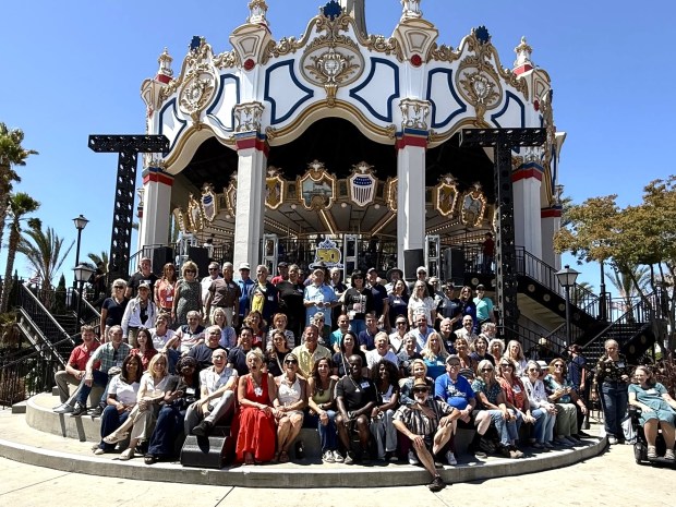 Members of the show operations team who worked at Marriott's Great America in the 1970s and 1980s pose in front of the Columbia carousel during a reunion at California's Great America in Santa Clara on Saturday, July 18, 2026. (Photo courtesy Michael Mulcahy)