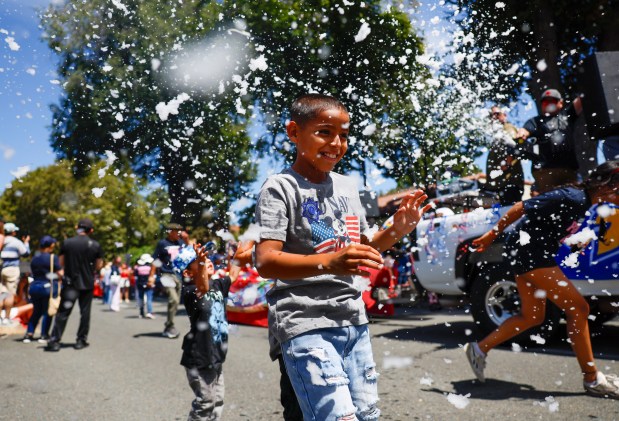 Junior, did not give his last name, 9, of San Jose, plays with bubbles during the RW&B Parade along The Alameda in San Jose, Calif., on Saturday, July 4, 2026. (Shae Hammond/Bay Area News Group)