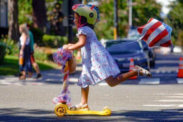 A girl rides her scooter during the RW&B Parade along The Alameda in San Jose, Calif., on Saturday, July 4, 2026. (Shae Hammond/Bay Area News Group)