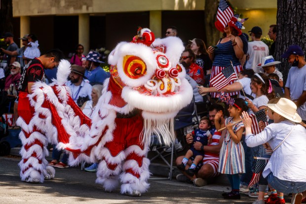 Dragon dancers interact with people during the RW&B Parade along The Alameda in San Jose, Calif., on Saturday, July 4, 2026. (Shae Hammond/Bay Area News Group)