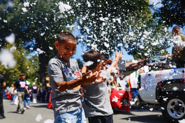 Junior, didn't want to give last name, 9, of San Jose, and his brother Zack, 7, right, play with bubbles during the RW&B Parade along The Alameda in San Jose, Calif., on Saturday, July 4, 2026. (Shae Hammond/Bay Area News Group)