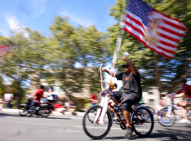 Marcus Rodriguez, of San Jose, rides his bike with the American Flag during the RW&B Parade along The Alameda in San Jose, Calif., on Saturday, July 4, 2026. (Shae Hammond/Bay Area News Group)