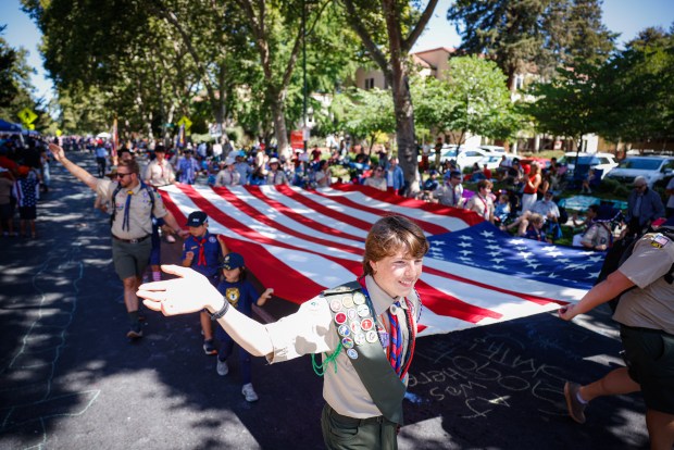 Boy Scouts of America troop 390 from San Jose carries an American Flag during The Rose, White and Blue 4th of July celebration and parade on The Alameda in San Jose, Calif., on Friday, July 4, 2025. (Shae Hammond/Bay Area News Group)