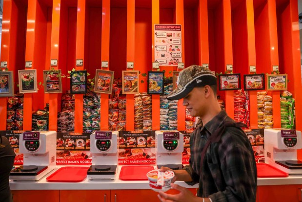 A customer carries his instant ramen bowl after serving himself at a self-service instant ramen station during the grand opening of Sakura Market, a new Japanese market in downtown San Jose, Calif., on Friday, July 24, 2026. (Ray Chavez/Bay Area News Group)