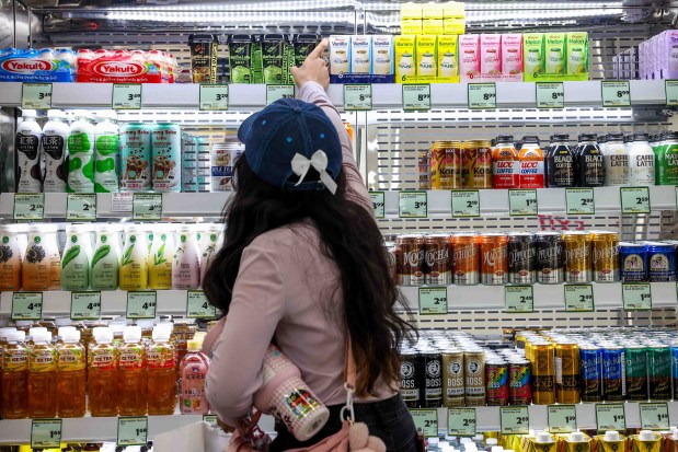 A customer grabs a cold drink during the grand opening of Sakura Market, a new Japanese market in downtown San Jose, Calif., on Friday, July 24, 2026. (Ray Chavez/Bay Area News Group)
