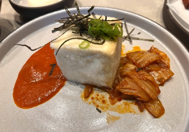 Doobu kimchi, a fried block of organic tofu with sauteed kimchi and kimchi puree, is served at Twinflame, which opened in July 2026. (John Metcalfe/Bay Area News Group)