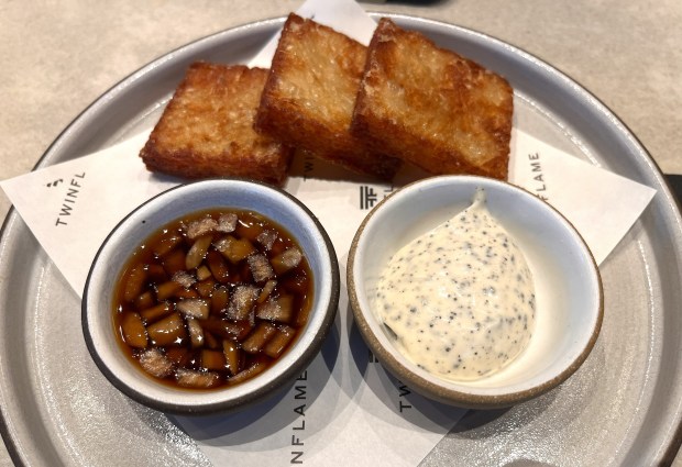 The gamja jeon, crispy potato pancakes served with truffle aioli and tamari-marinated onions, is an appetizer offered at Twinflame, which opened in July 2026. (John Metcalfe/Bay Area News Group)