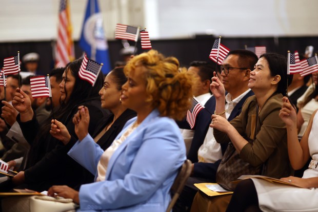 New citizens participate in a naturalization ceremony aboard the USS Hornet Sea, Air & Space Museum on Wednesday, July 1, 2026, in Alameda, Calif. A total of 76 community members from 28 different countries became new American citizens during the ceremony. (Aric Crabb/Bay Area News Group)