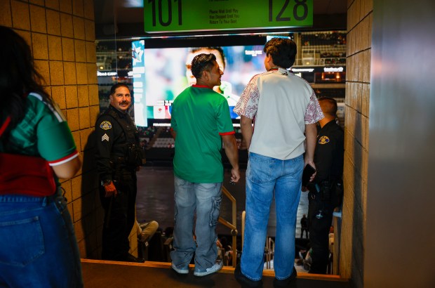 San Jose Police Officers stand guard as Mexico fans wander the concourse at the SAP Center before the Mexico versus England Round of 16 match for the FIFA World Cup at the Soccer Celebration presented by the San José Sports Authority at the SAP Center in San Jose, Calif., on Sunday, July 5, 2026. (Nhat V. Meyer/Bay Area News Group)