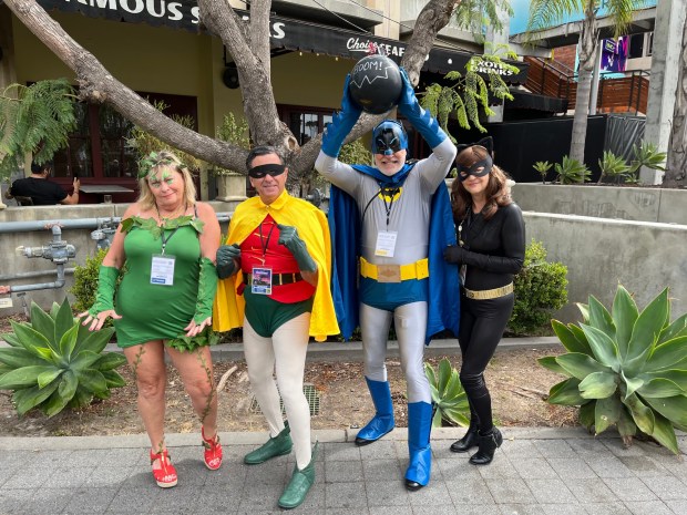 Marty Axiotis (Poison Ivy), George Axiotis (Robin), Wayne Jacobs (Batman) and Jackie Jacobs (Catwoman) traveled from the Washington, D.C. area to attend their first Comic-Con Friday. (Abby Hamblin / The San Diego Union-Tribune)