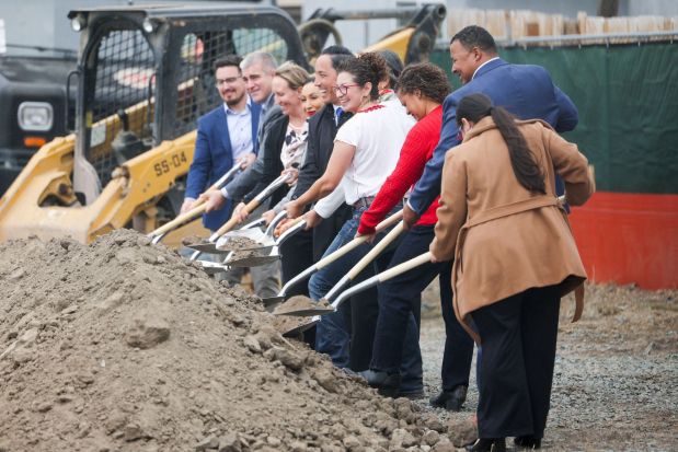 Lisa Cuestas, CEO of Casa Familiar, center, along with local and state officials and project partners, break ground on Avanzando Community Land Trust on Cypress Drive in San Ysidro on Tuesday, Oct. 14, 2025. (Meg McLaughlin / The San Diego Union-Tribune)