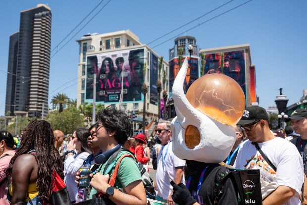 San Diego, CA - People flood across the trolley tracks heading towards the Convention Center during Comic-Con on Saturday, July 25, 2026, in San Diego, CA. (Luke Johnson / The San Diego Union-Tribune)