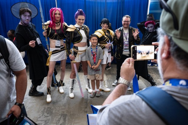 San Diego, CA - People take photos with cosplayers in the Convention Center lobby during Comic-Con on Saturday, July 25, 2026, in San Diego, CA. (Luke Johnson / The San Diego Union-Tribune)