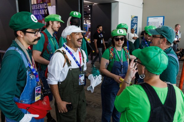 San Diego, California - Attendees cosplaying as Luigi from the video game Super Mario Bros. meet up at Comic-Con on Saturday, July 25, 2026. (Kristian Carreon / The San Diego Union-Tribune)