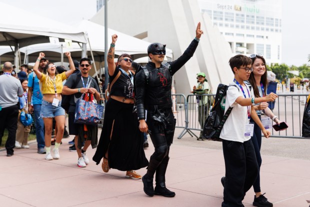 San Diego, California - Attendees cheer as they are escorted into Hall H, where the Marvel panel is held, during Comic-Con on Saturday, July 25, 2026. Attendees said that they waited 16 hours in line. (Kristian Carreon / The San Diego Union-Tribune)