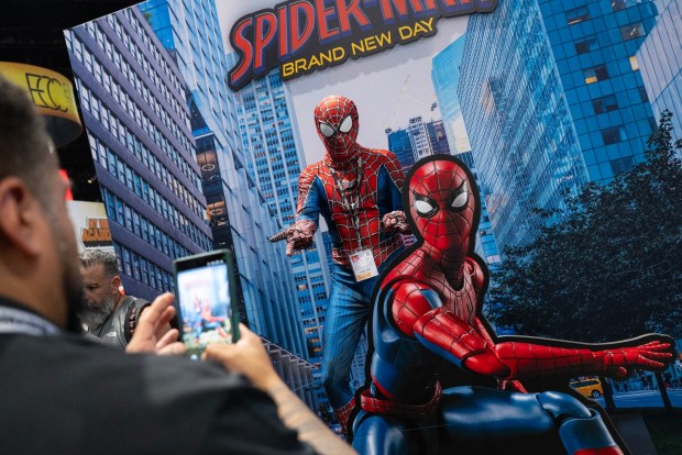 San Diego, CA - Henry Moore poses with a Spider-Man statue in the main exhibit hall during Comic-Con on Saturday, July 25, 2026, in San Diego, CA. (Luke Johnson / The San Diego Union-Tribune)