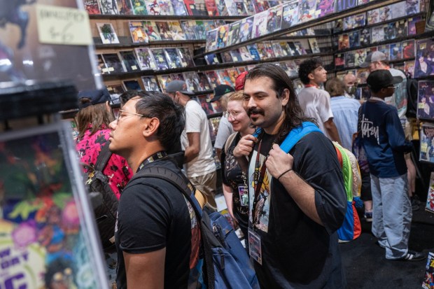 San Diego, CA - People look at comic books at a booth in the main exhibit hall during Comic-Con on Saturday, July 25, 2026, in San Diego, CA. (Luke Johnson / The San Diego Union-Tribune)
