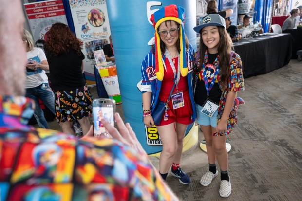 San Diego, CA - (L-R) Love on the Spectrum Star, Dani Bowman, takes a photo with Lily Robinson, 11, in the Convention Center during Comic-Con on Saturday, July 25, 2026, in San Diego, CA. (Luke Johnson / The San Diego Union-Tribune)