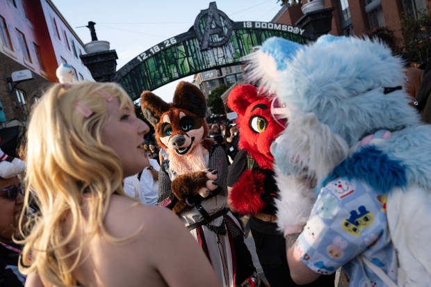San Diego, CA - People dressed as "frurries" talk at the entry way to the Gaslamp during Comic-Con on Saturday, July 25, 2026, in San Diego, CA. (Luke Johnson / The San Diego Union-Tribune)