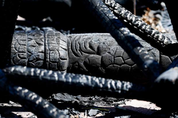 Charred tiki sculptures are seen at Harvey Mendiola's home after the Creelman fire on Thursday, July 23, 2026 in Ramona, California. (Meg McLaughlin / The San Diego Union-Tribune)