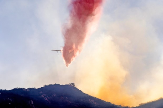 Ramona, CA - Crews drop fire retardant as they battle the Creelman fire which crew quickly but has since been slowed significantly on Wednesday, July 22, 2026, in Ramona, CA. (Luke Johnson / The San Diego Union-Tribune)