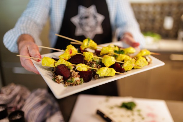 San Diego County Sheriff's Deputy Joe Jackson presents a meal he made as part of a cooking lesson recorded for department employees. Jackson was a professional chef before becoming a sworn deputy in early 2021. (Photos by Jeremy Fabunan provided by the San Diego County Sheriff's Office)