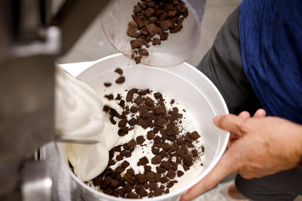 Chris Wynn, co-owner of Wynston's Ice Cream Co., adds ingredients for ice cream on Thursday, July 16, 2026 in San Marcos. (Meg McLaughlin / The San Diego Union-Tribune)
