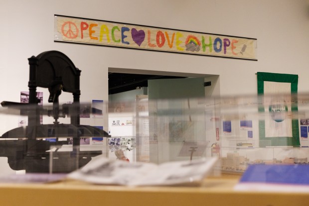 A banner that was on display at a vaccination site at the Del Mar Fairgrounds during the coronavirus pandemic hangs in the America at 250 exhibition at the San Diego History Center in Balboa Park on Tuesday, June 30, 2026. (Kristian Carreon / The San Diego Union-Tribune)