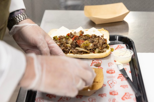 San Diego, CA - Head Chef Ciarán Duffy demonstrates to a group of food journalists and influencers how to make the new Philly Cheesesteak at the Jack in the Box headquarters on Wednesday, July 15, 2026, in San Diego, CA. (Luke Johnson / The San Diego Union-Tribune)