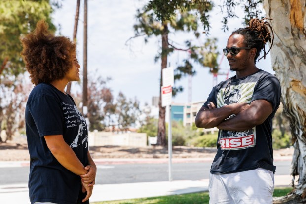 San Diego, California - Caitlin Radigan, chair of the county Juvenile Justice Commission, and vice chair Aaron Adkins chat outside outside Juvenile Court in San Diego on July 18: Saturday, July 18, 2026. (Kristian Carreon / The San Diego Union-Tribune)