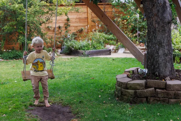 A backyard swing is part of the fun for 4-year-old Clay. (Kristian Carreon / The San Diego Union-Tribune)
