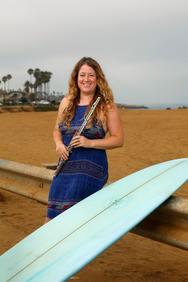 San Diego Symphony principal flute Rose Lombardo is also an avid surfer. She 's shown here at Sunset Cliffs on Aug. 7, 2025. in San Diego, CA. (K.C. Alfred / The San Diego Union-Tribune)