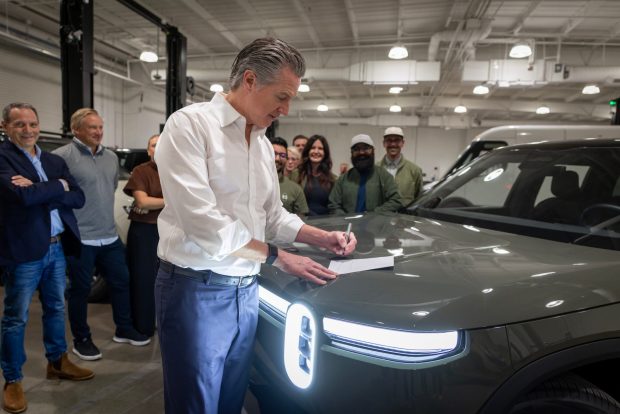 Gov. Gavin Newsom, while at Rivian Automotive, signs Senate Bill 168 that allows for a rebate program for electric vehicles within the state's 2026-27 budget. (California Governor's Office)