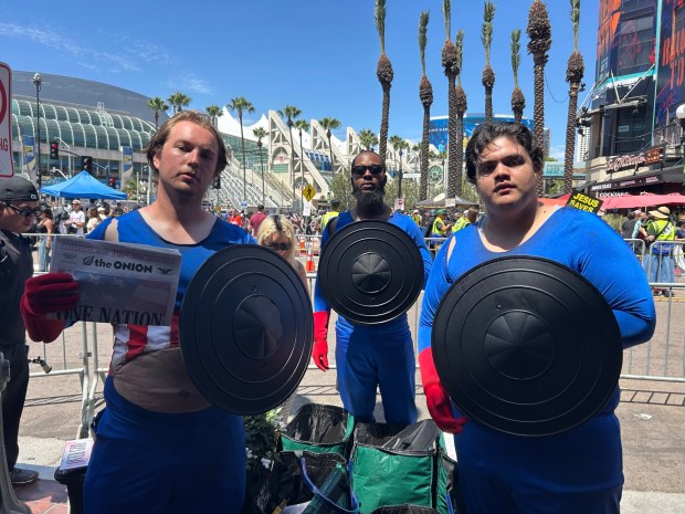 Visitors to downtown San Diego during Comic-Con Saturday could grab an edition of The Onion. (Madeleine Kashkooli / The San Diego Union-Tribune)