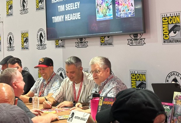 Comedian and voice actor Patton Oswalt signs comic books Saturday at Comic-Con. (Maya Santiago / The San Diego Union-Tribune)